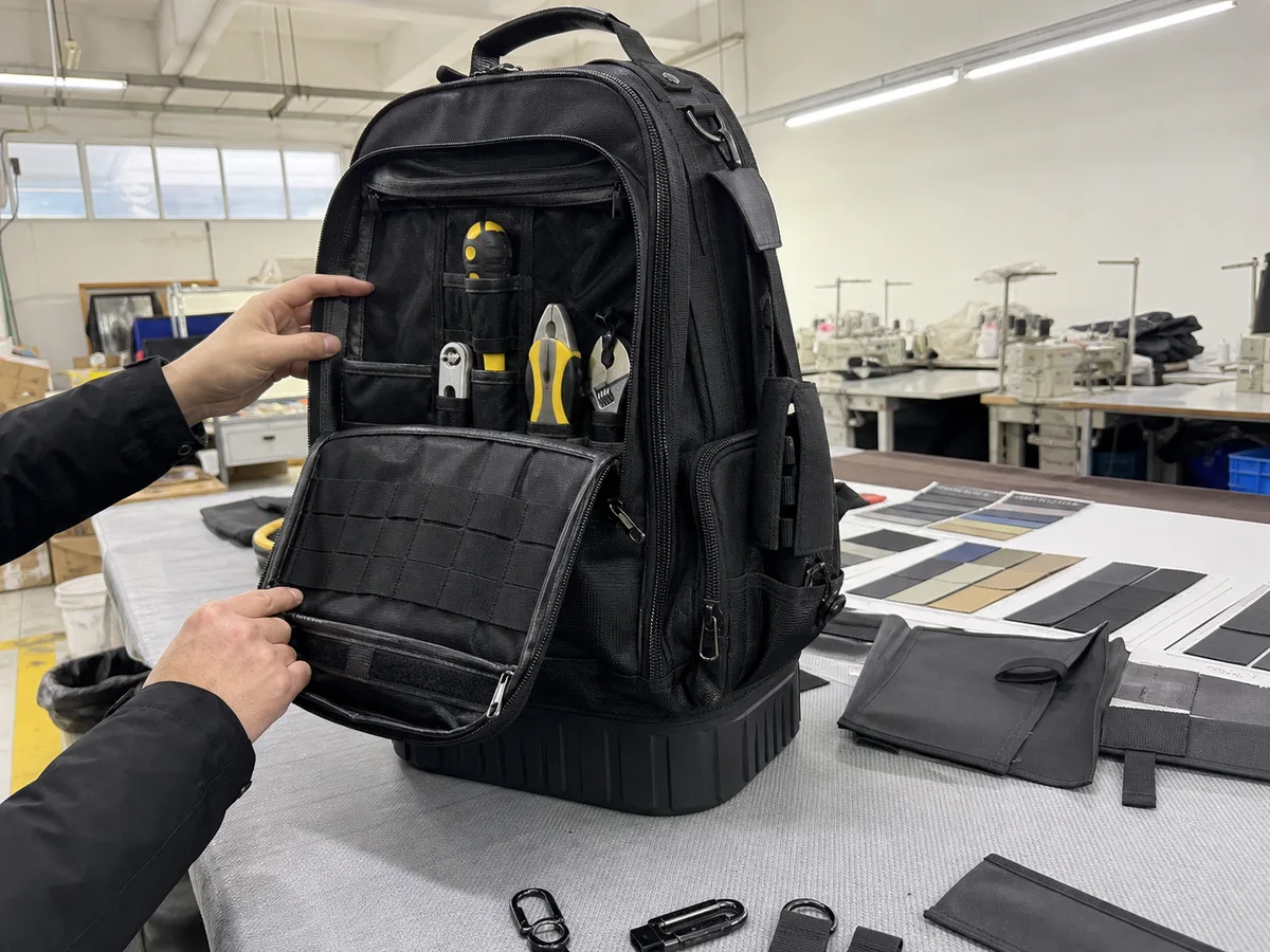 Phone photo of reinforced custom tool backpack materials and pocket layout review