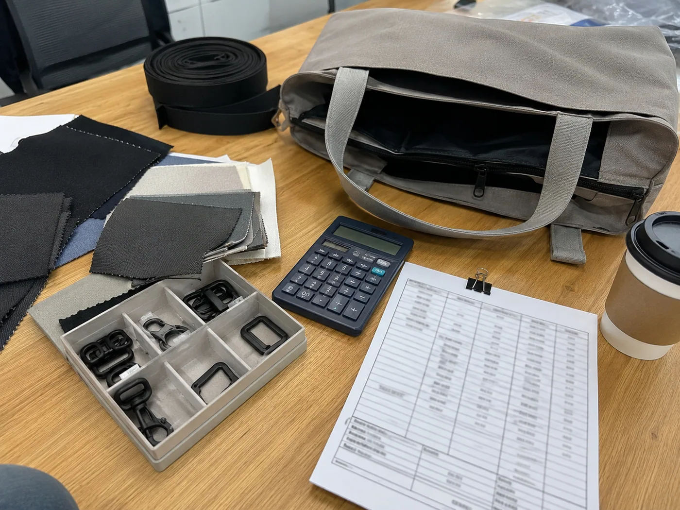 Smartphone-style backpack measurement on a factory table with tape measure, ruler, and sample tag