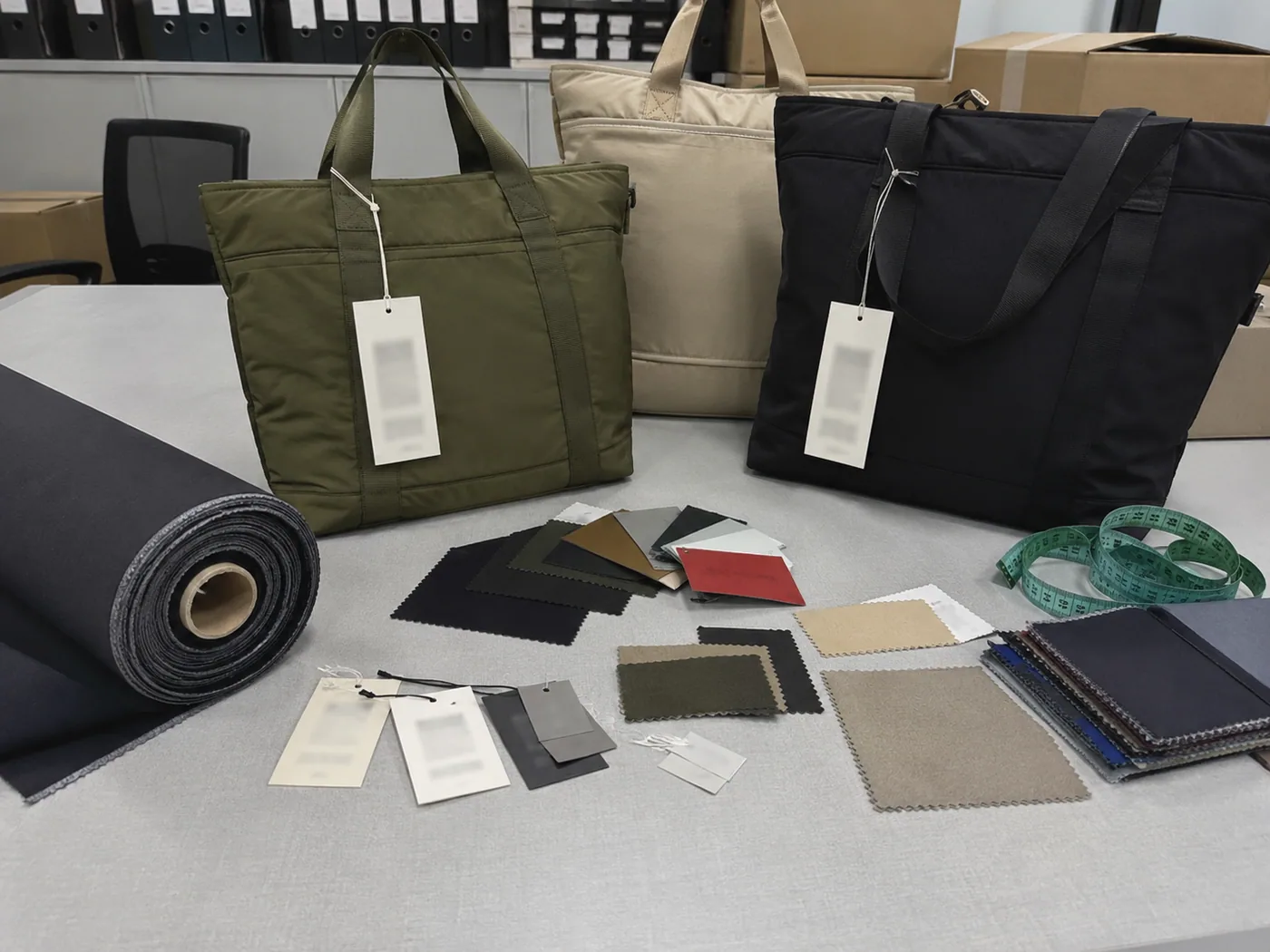 Smartphone-style compliance review table with bag samples, blurred hangtags, material swatches, measuring tape, and recycled fabric roll