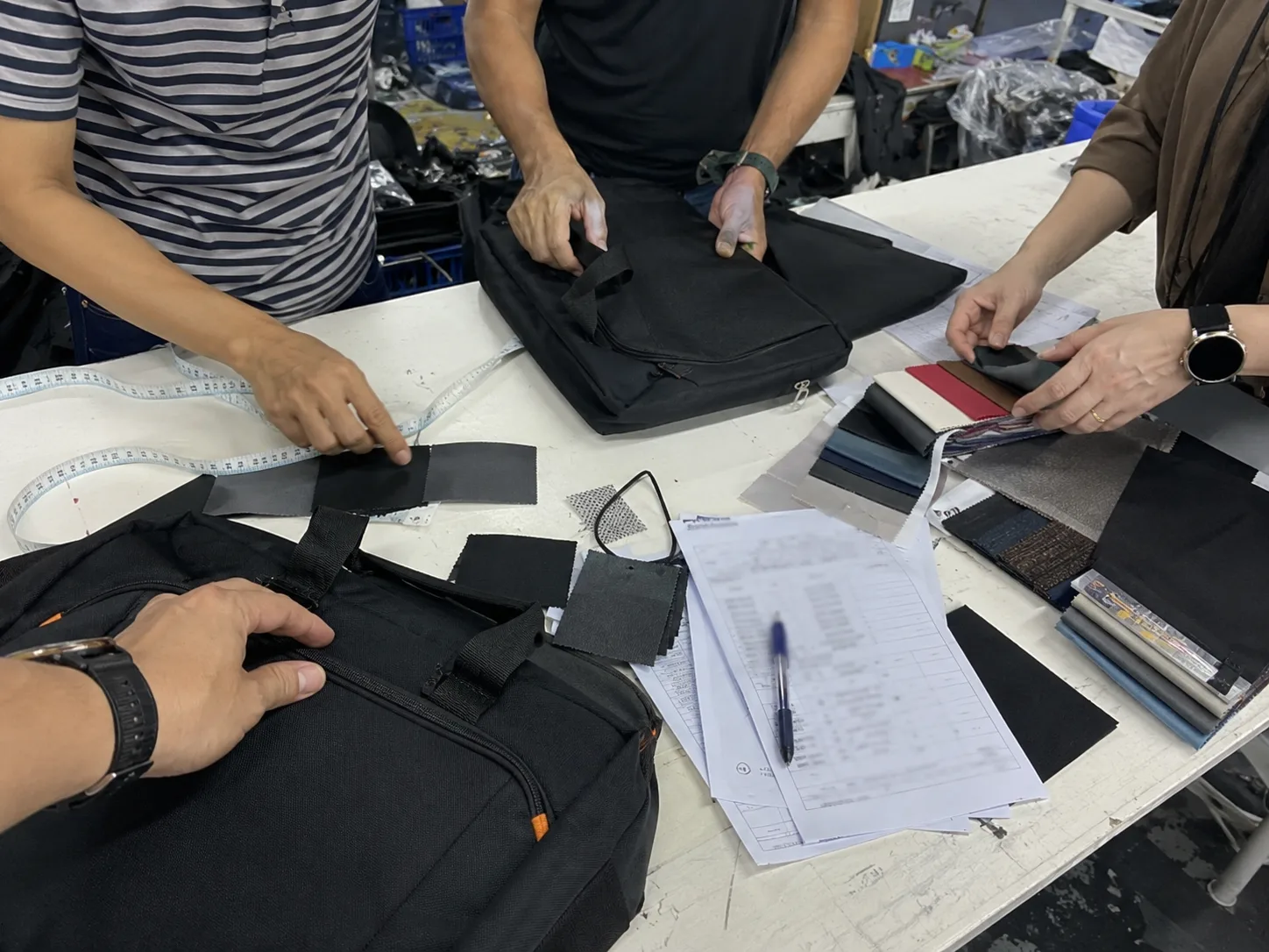 Connect5 factory team workbench with bag samples, swatches, and production notes