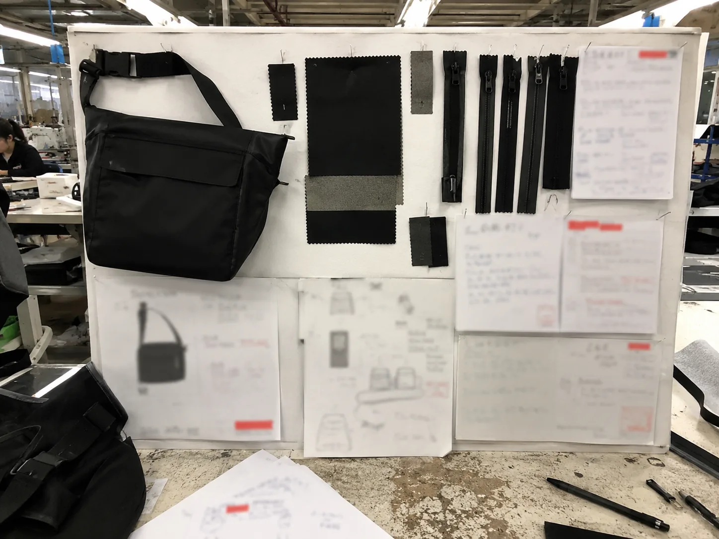 Bag sample development workflow board with redacted revision notes