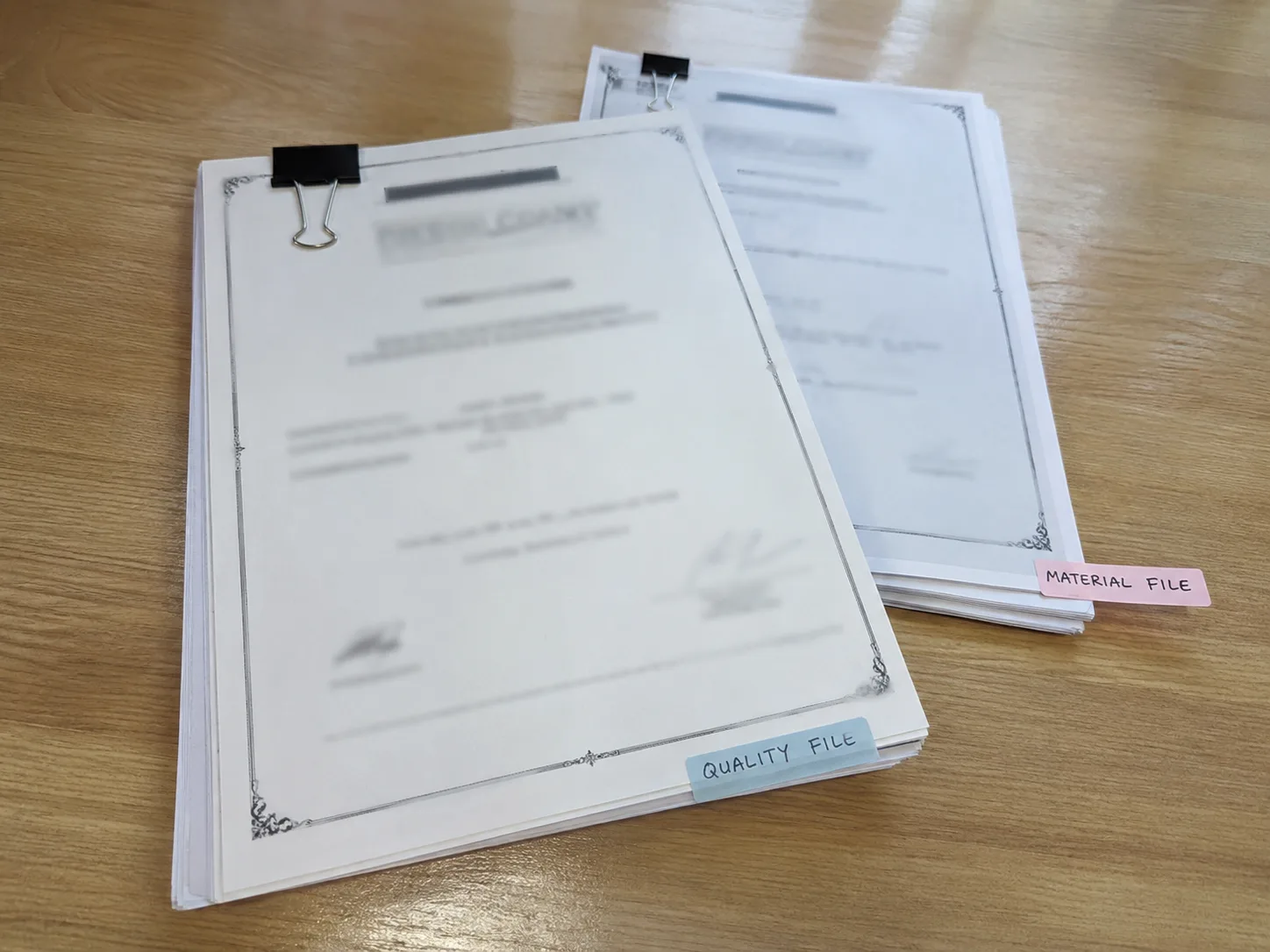 Redacted factory quality and compliance document stack